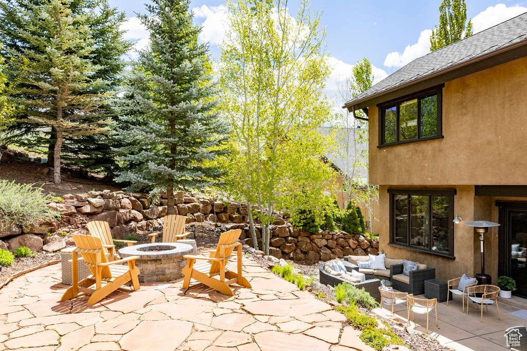 View of patio / terrace with an outdoor living space with a fire pit