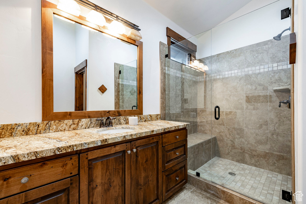 Bathroom featuring vanity and a stall shower