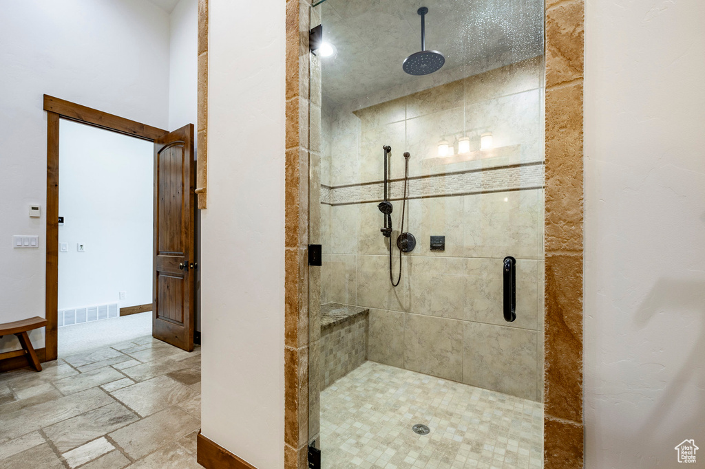 Bathroom with a stall shower and stone tile floors