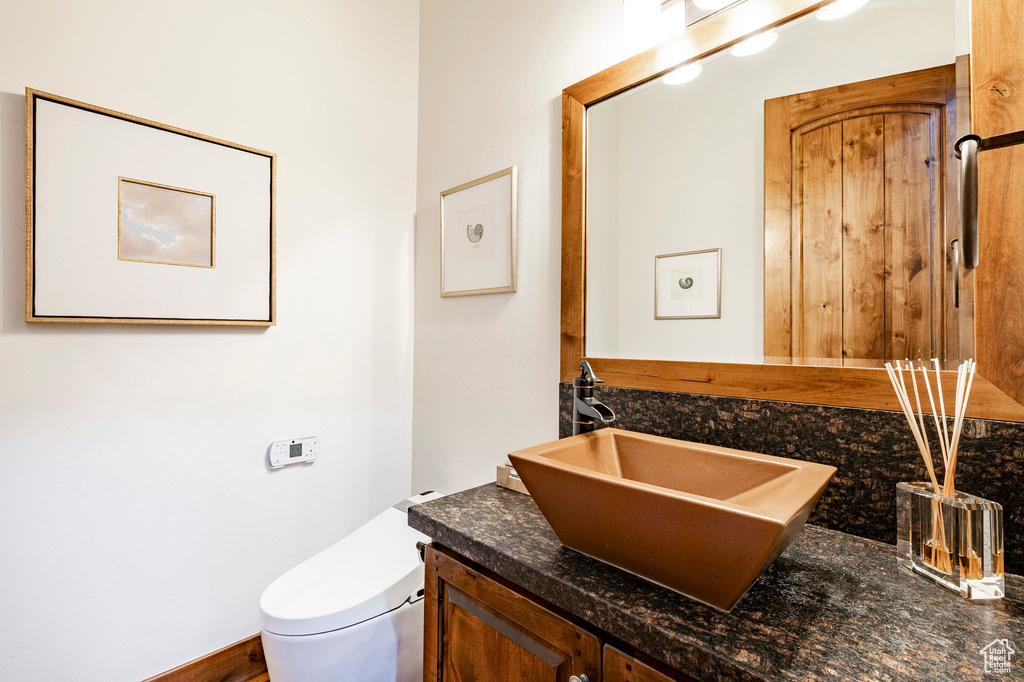 Bathroom featuring vanity and toilet
