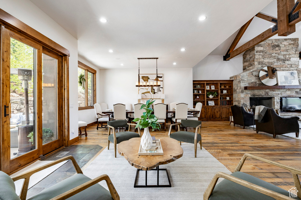 Living room with light wood-type flooring, recessed lighting, baseboards, and a stone fireplace