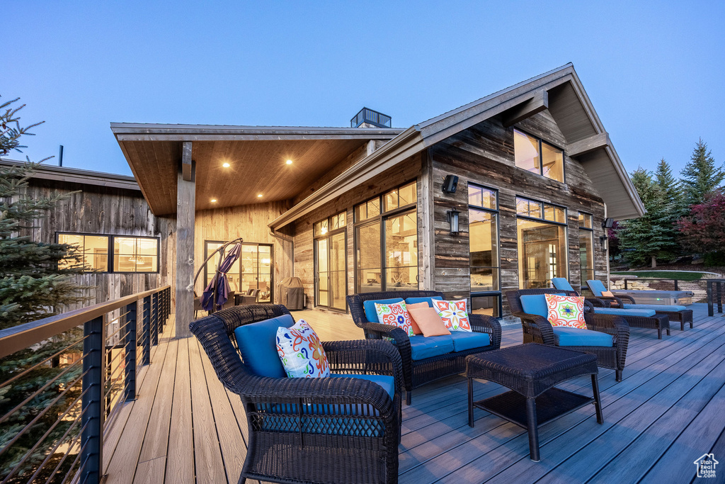 Wooden terrace featuring an outdoor living space