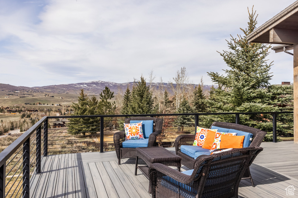 Deck with a mountain view and an outdoor living space