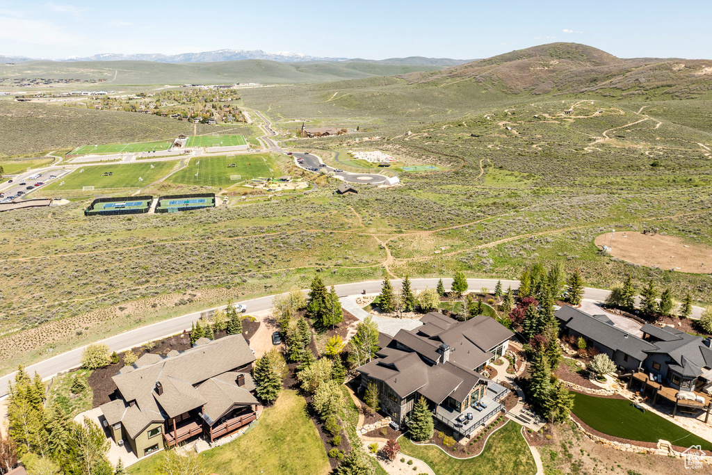 Aerial view of property\'s location with a mountain backdrop and nearby suburban area