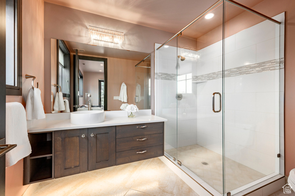 Full bathroom with a shower stall, vanity, tile patterned flooring, and recessed lighting