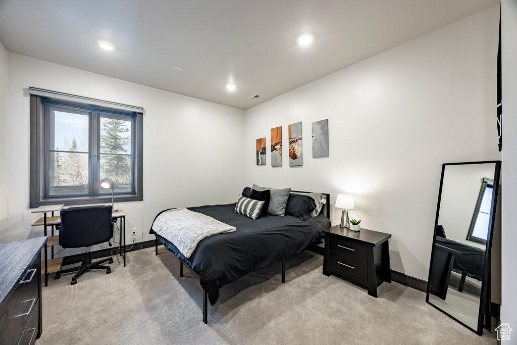 Bedroom featuring light colored carpet, a desk, baseboards, and recessed lighting