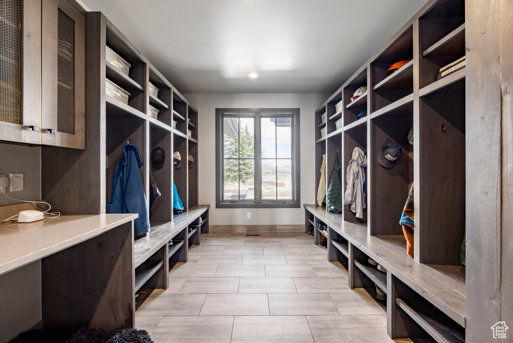 Mudroom with baseboards and light tile patterned floors