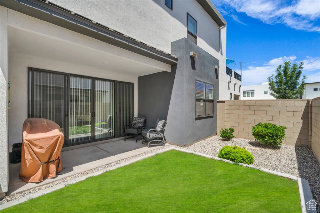 Rear view of property with stucco siding and a patio area