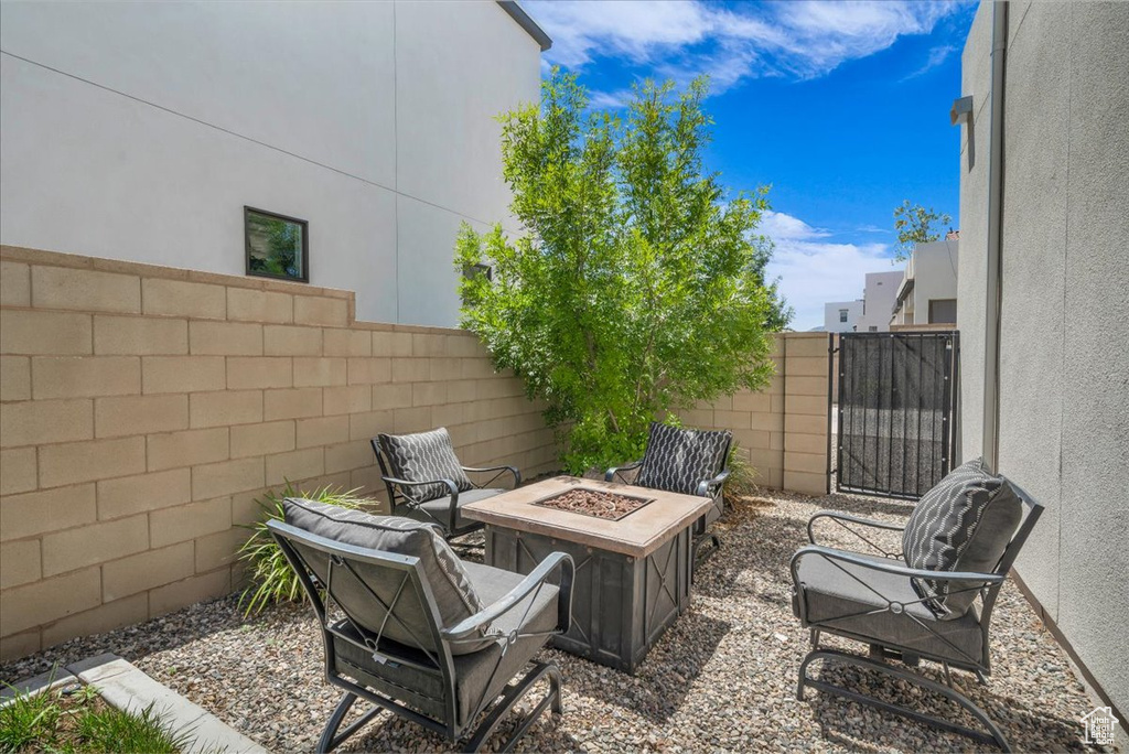 Fenced backyard with a fire pit and a gate