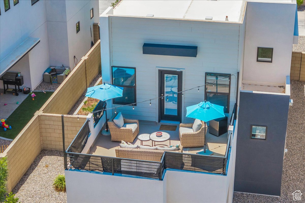 Back of property with an outdoor living space and a patio area