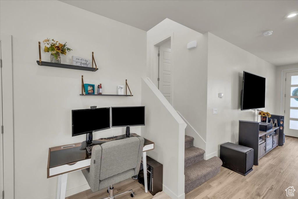 Office with light wood-style flooring and baseboards