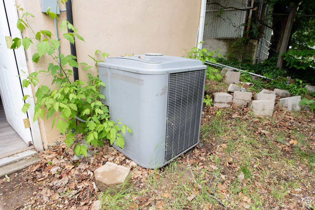 Exterior view of central air condition unit and stucco siding