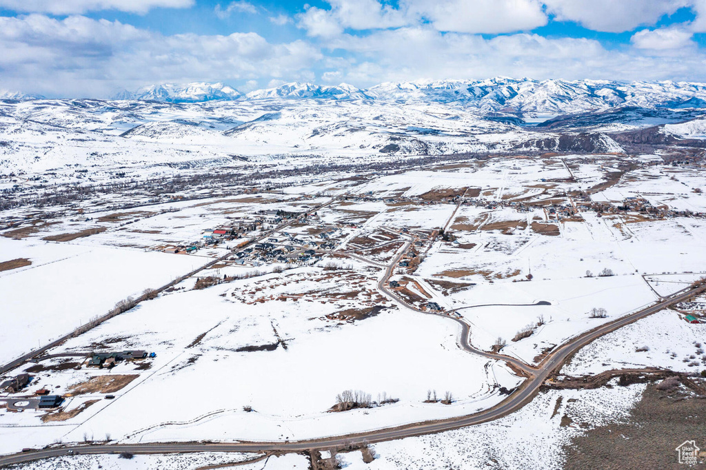 Snowy aerial view featuring a mountain view