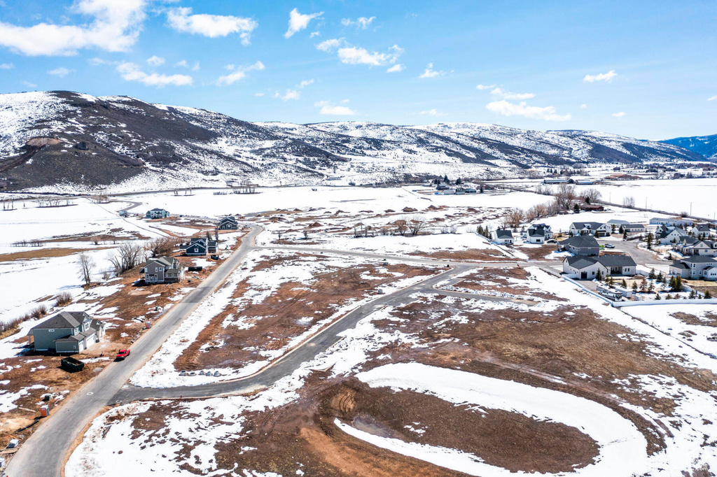 Snowy aerial view featuring a mountain view