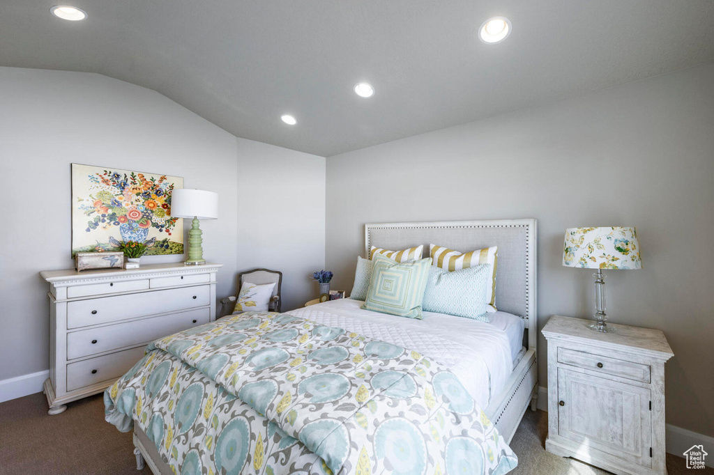 Bedroom with vaulted ceiling, recessed lighting, baseboards, and carpet flooring