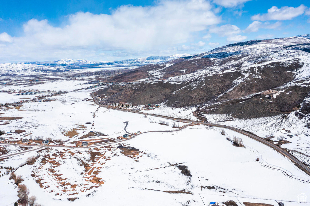 Snowy aerial view featuring a mountain view
