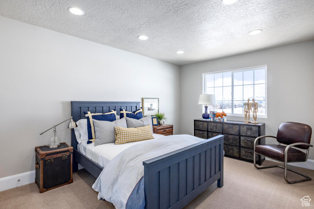 Bedroom featuring carpet floors, a textured ceiling, and recessed lighting