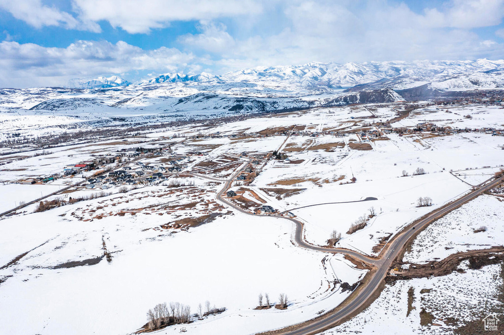 Snowy aerial view featuring a mountain view