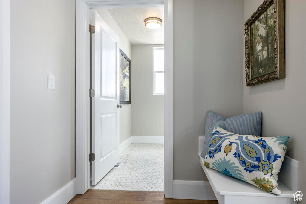 Corridor with wood finished floors and baseboards