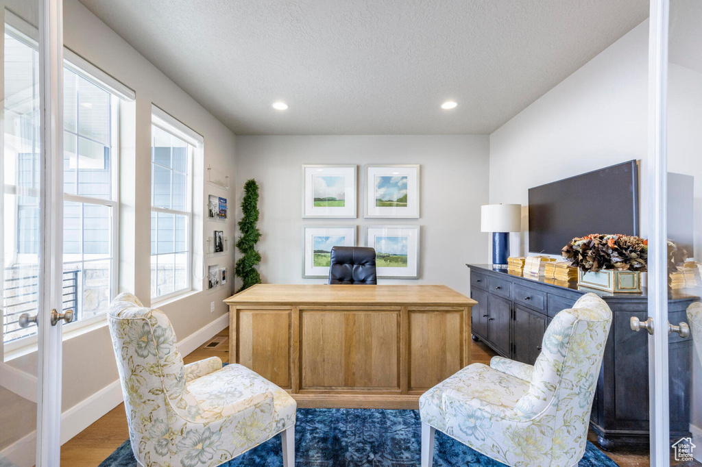 Office area featuring baseboards, wood finished floors, recessed lighting, a textured ceiling, and french doors