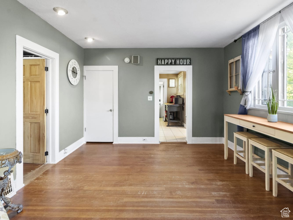 Foyer with wood finished floors and baseboards