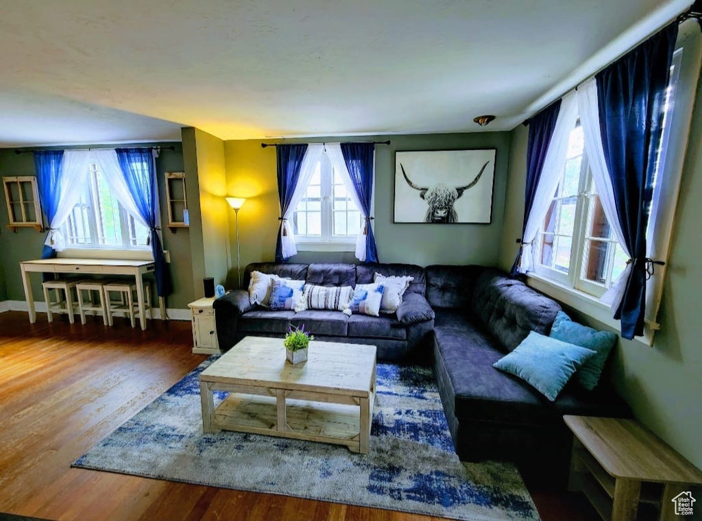 Living area with wood finished floors and baseboards