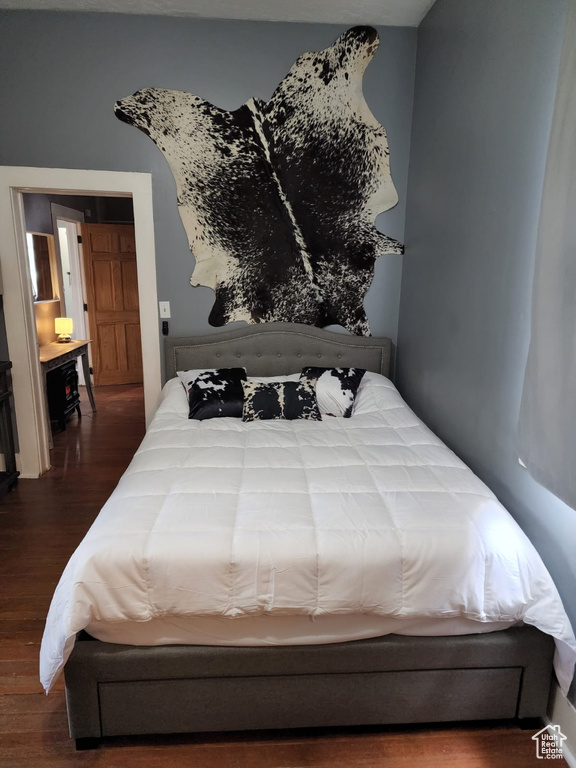 Bedroom with dark wood-type flooring