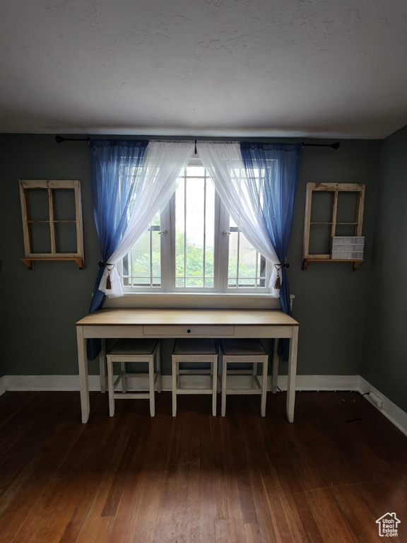 Sitting room featuring healthy amount of natural light, baseboards, and wood finished floors
