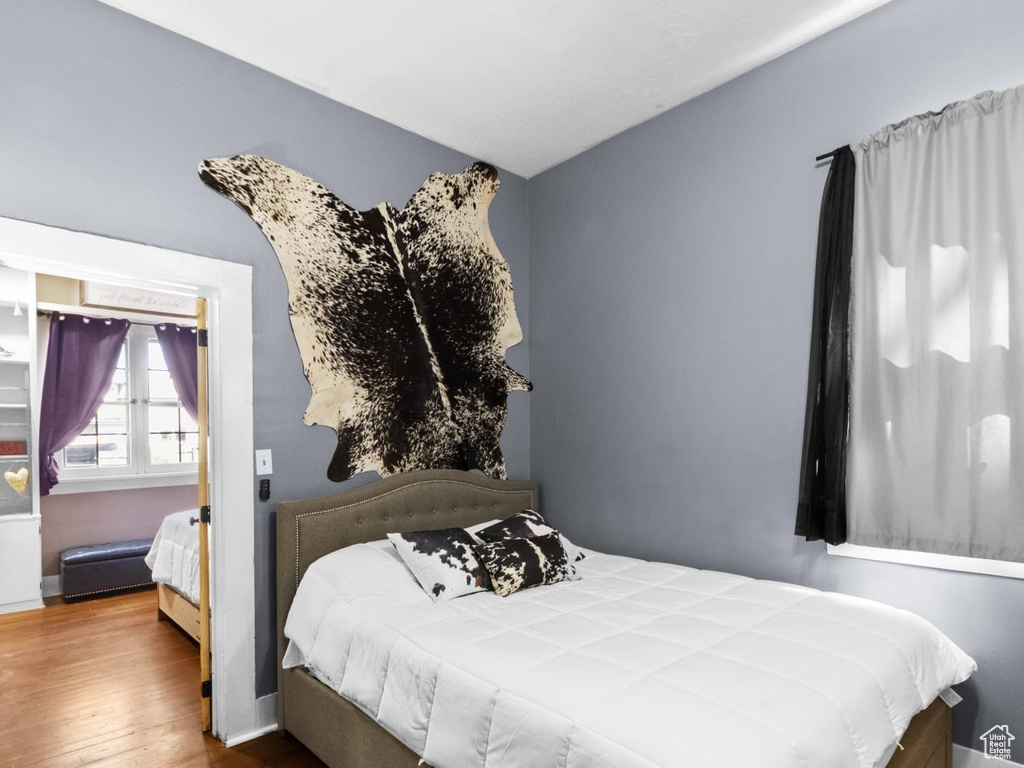 Bedroom featuring wood finished floors and baseboards