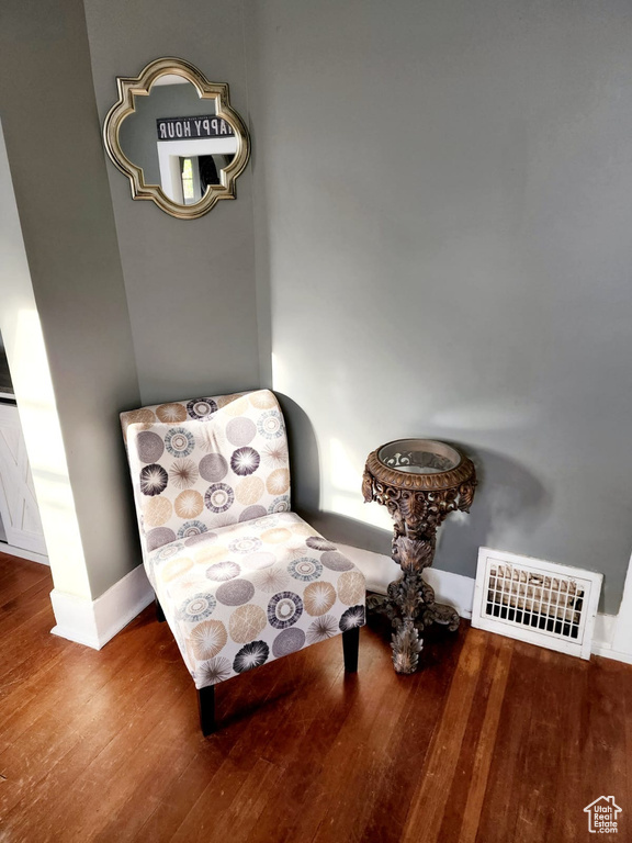 Sitting room with wood finished floors and baseboards