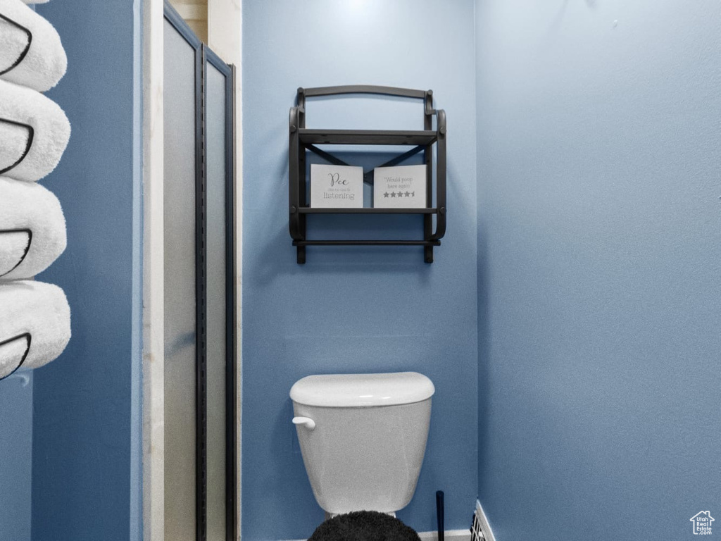 Bathroom featuring a stall shower and toilet