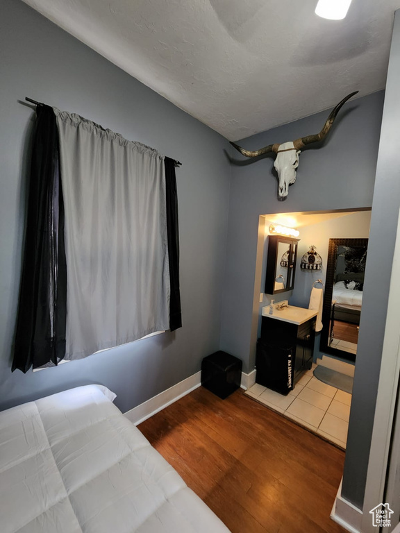 Bedroom featuring wood finished floors and baseboards