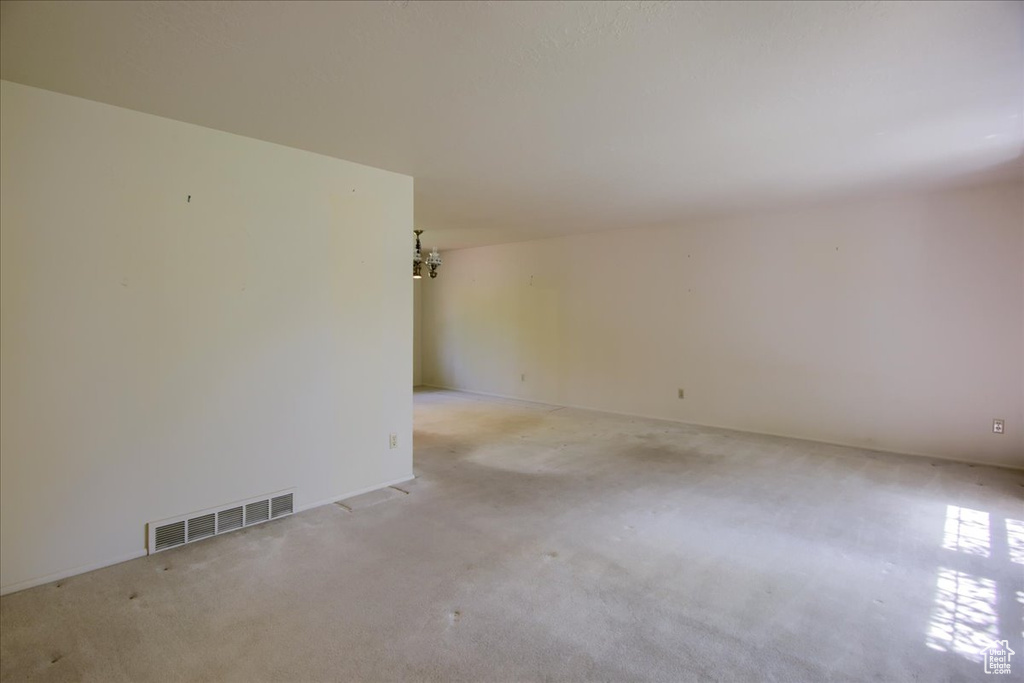 Spare room featuring light colored carpet