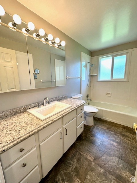 Bathroom with vanity, toilet, and bathtub / shower combination