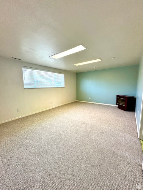Carpeted spare room with baseboards