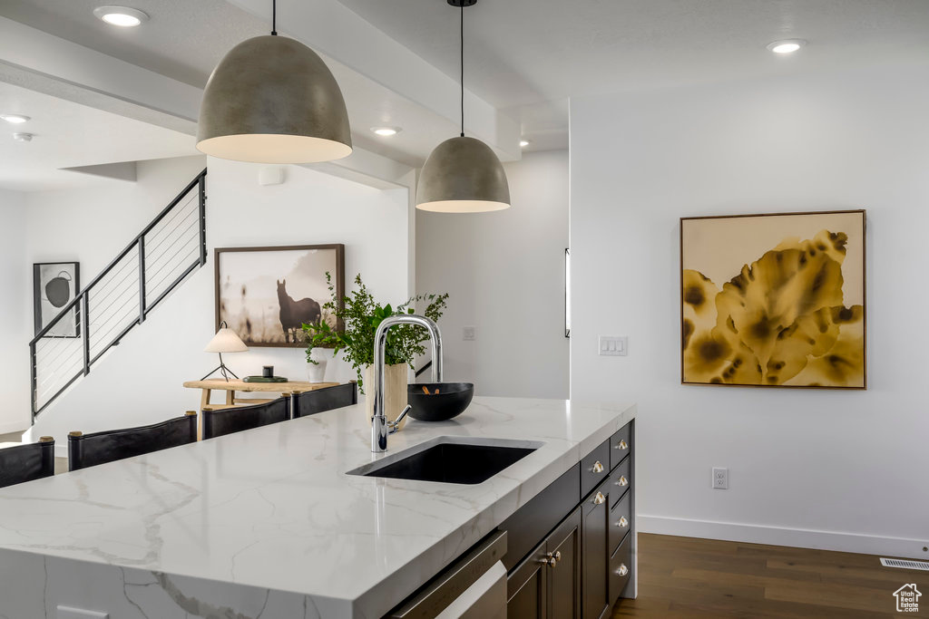 Kitchen with a sink, dark wood-style flooring, recessed lighting, dishwasher, and pendant lighting
