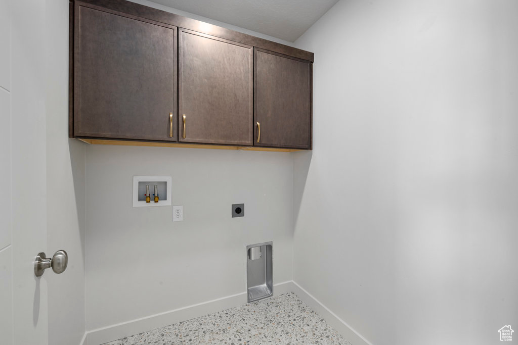 Laundry room featuring baseboards, cabinet space, hookup for a washing machine, and electric dryer hookup