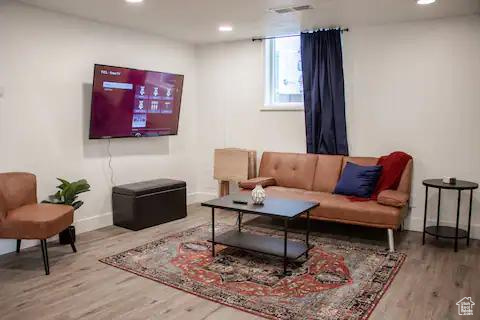 Living room featuring wood finished floors, baseboards, and recessed lighting