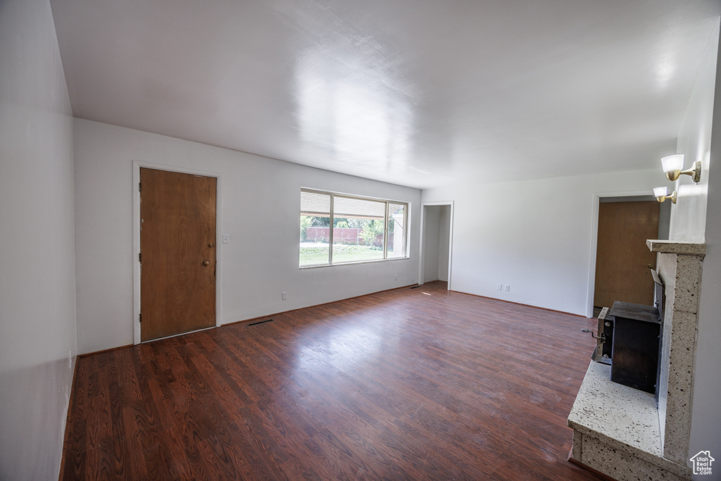 Unfurnished living room with dark wood-style floors