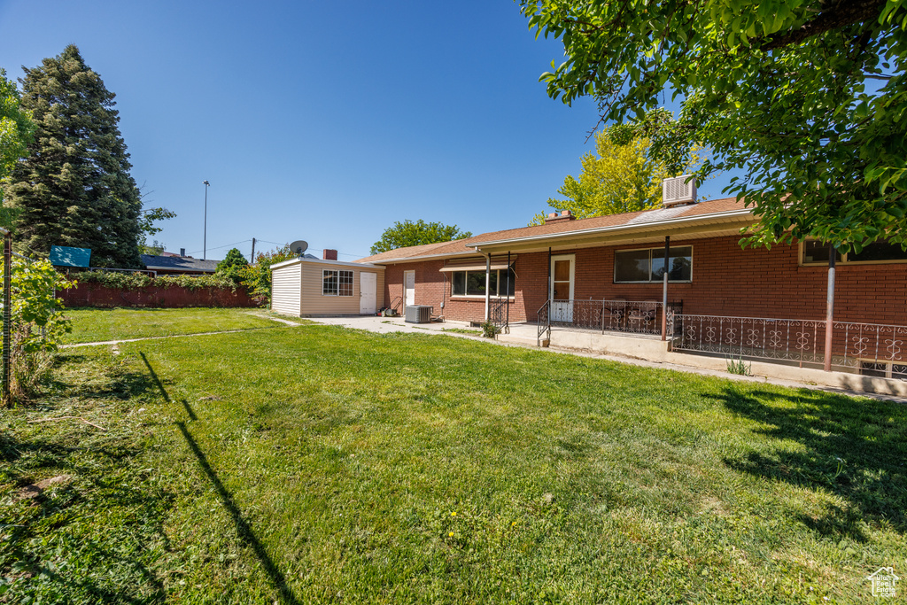 Back of property with brick siding and a patio area