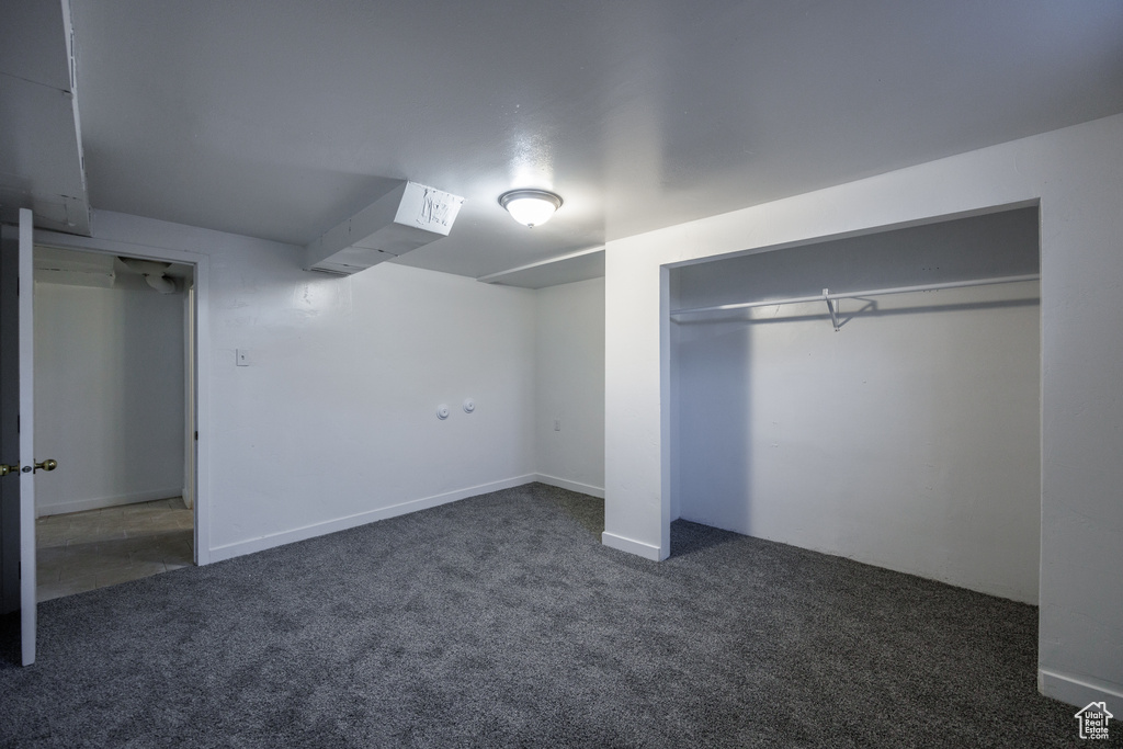 Unfurnished bedroom with carpet flooring and a closet