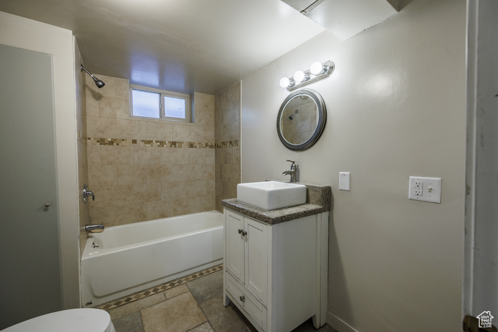 Bathroom with vanity, bathtub / shower combination, and toilet