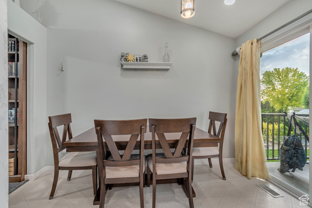 Dining space featuring healthy amount of natural light, light floors, and baseboards