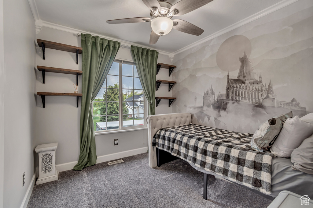 Bedroom with ornamental molding, multiple windows, carpet floors, baseboards, and a ceiling fan