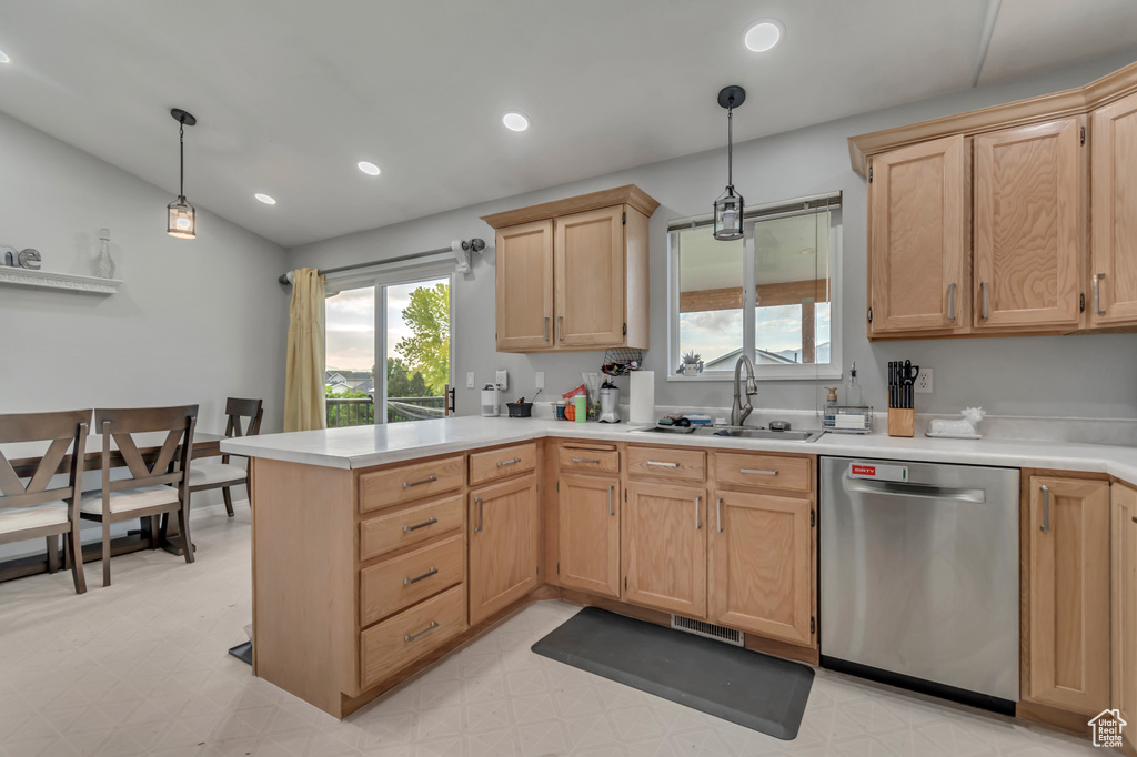 Kitchen featuring dishwasher, light brown cabinetry, a peninsula, a sink, and recessed lighting