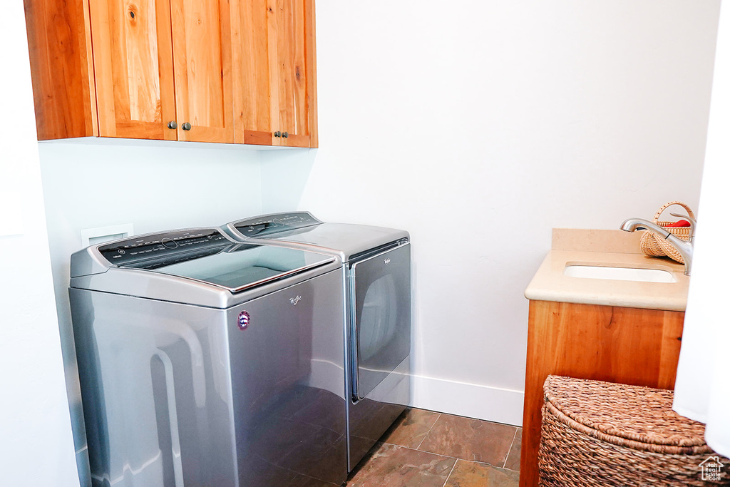 Laundry room featuring cabinet space, independent washer and dryer, and baseboards