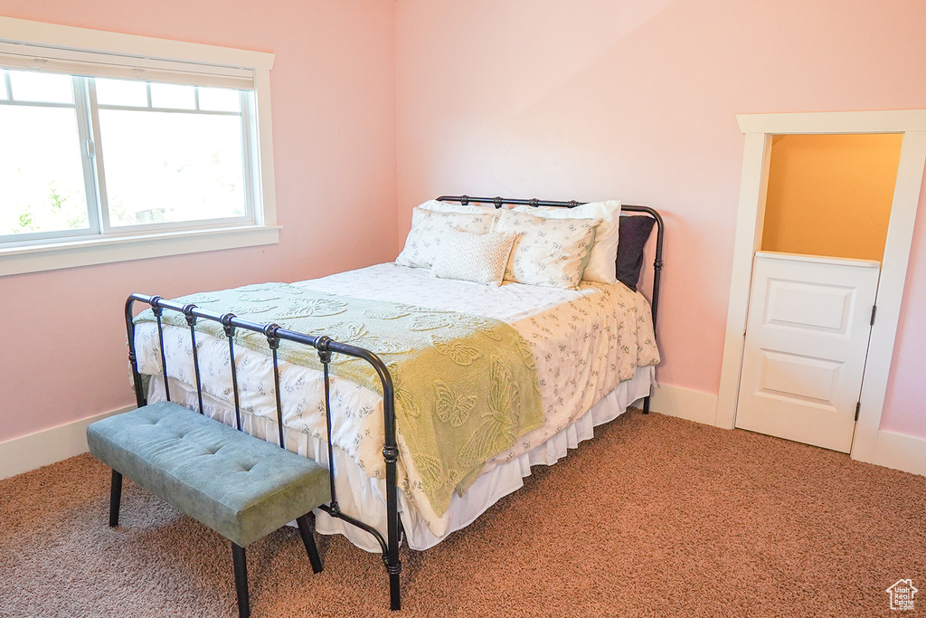 Bedroom with light carpet and baseboards