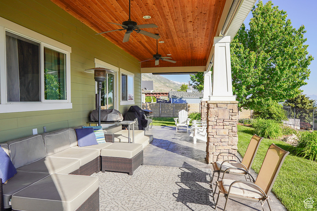View of patio featuring a grill, an outdoor living space, and a ceiling fan