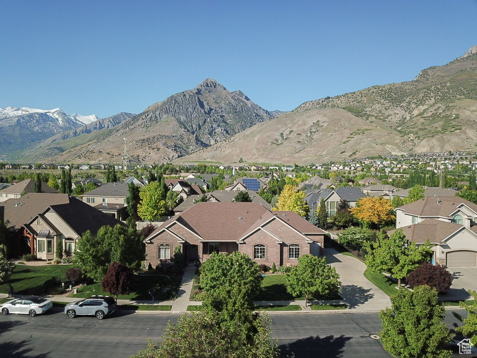 View of mountain backdrop featuring nearby suburban area