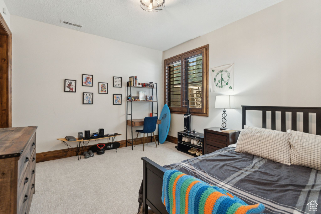 Carpeted bedroom featuring baseboards